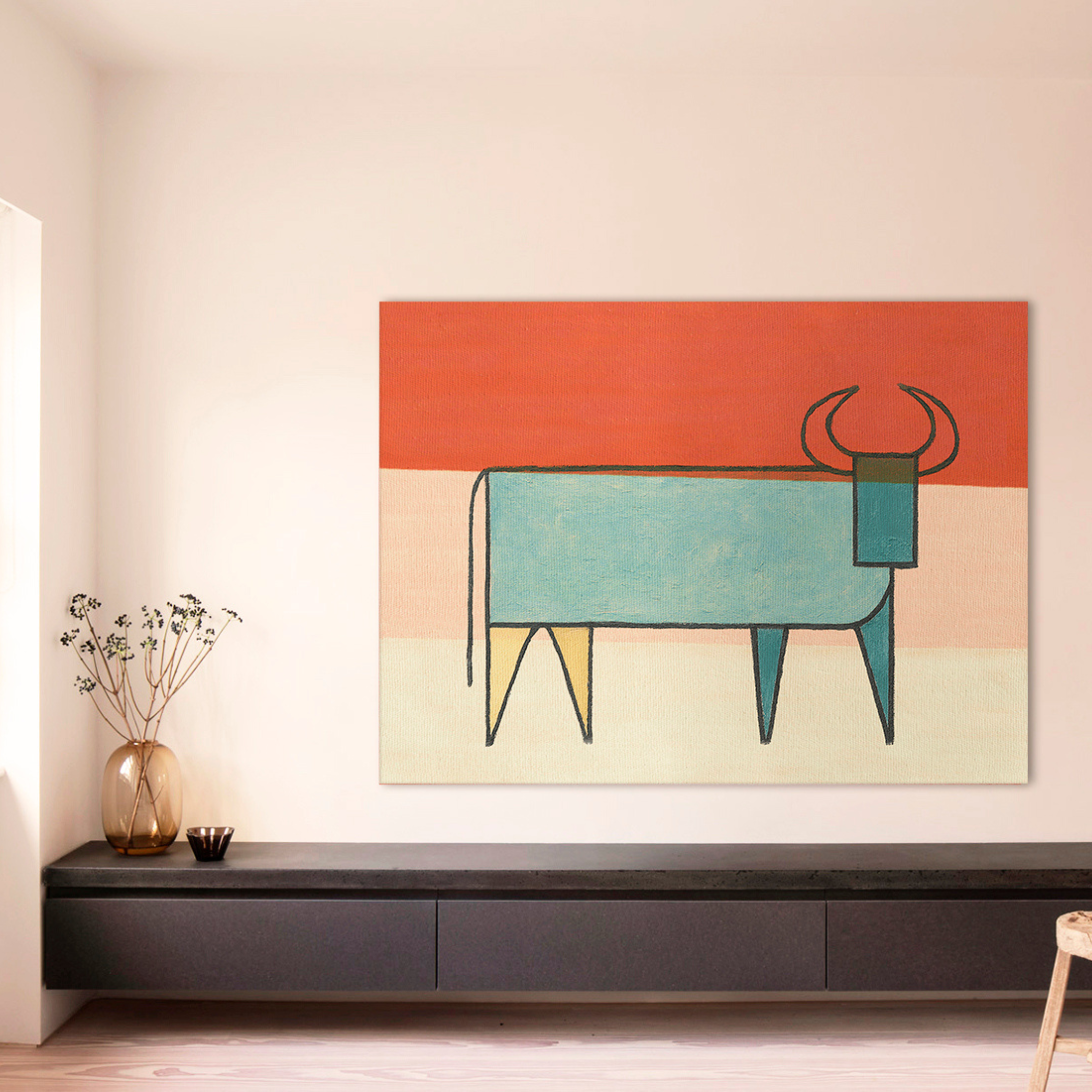 Colorful abstract bull painting with a turquoise body and orange background in a modern setting - Vybe Interior